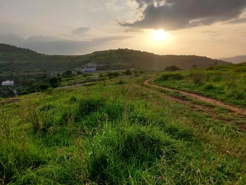 An old earthen road path running beyond the hills Stock Photos