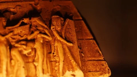Old Egyptian Papyrus Rack Focus to Carved Pyramid Sculpture Closeup Lighted  Stock Footage 75273107