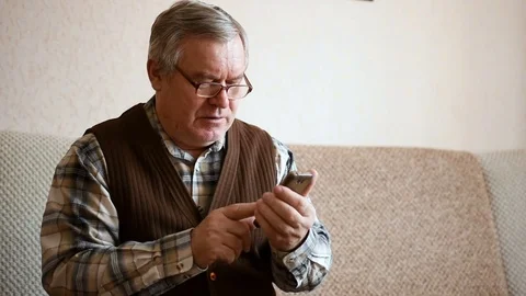 Old elder senior man on mobile smart phone Stock Footage