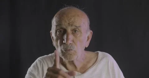 An old, elderly senior man is shushing. Saying stop with his hand gestures. Stock Footage 136763008