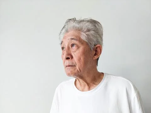 Old Elderly Thin Asian Man Standing Against Wall Background Stock-Fotos