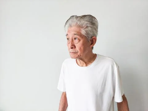 Old Elderly Thin Asian Man Standing Against Wall Background Stock-Fotos