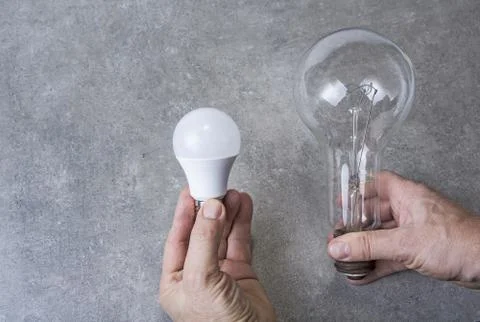 Old electric bulb with ecologic led one. Save energy concept. Stock Photos