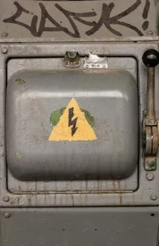 Old electric high-voltage switch with a painted danger sign. dangerously kill Stock Photos
