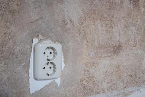 Old electric plug socket closeup on vintage wall Stock Photos