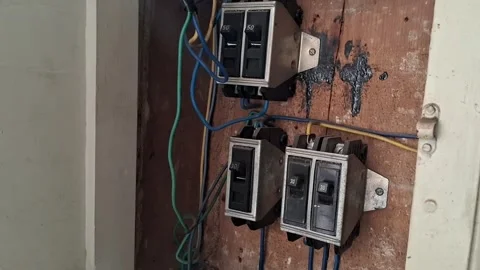 Old electrical breaker panel with exposed wiring in motion video Stock Footage 339248189