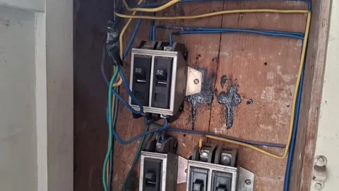Old electrical circuit breaker panel with wires in motion footage Stock Footage 339248194