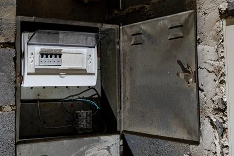 Old electrical fuse box on the basement wall, power outage repair in an old.. Stock Photos