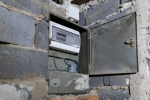 Old electrical fuse box on the wall in the basement, removing power failure.. Stock Photos