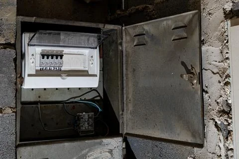 Old electrical fuse box on the wall in the basement, removing power failure.. Stock Photos
