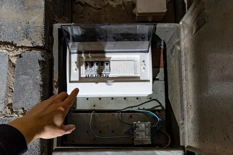Old electrical fuse box on the wall in the basement, removing power failure.. Stock Photos