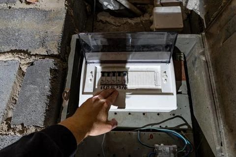 Old electrical fuse box on the wall in the basement, removing power failure.. Stock Photos