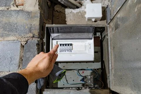 Old electrical fuse box on the wall in the basement, removing power failure.. Stock Photos