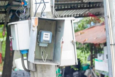 Old electrical meter mounted at the post. Stock Photos