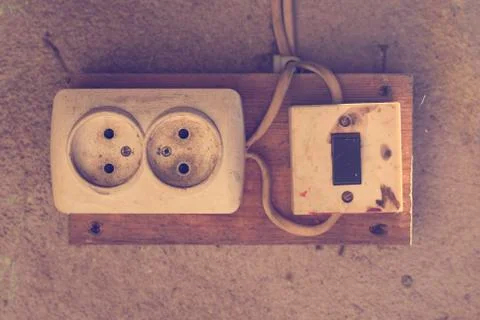 Old electrical outlet and switch close-up. Stock Photos