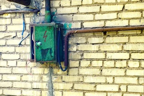 Old electrical panel on a brick wall Stock Photos