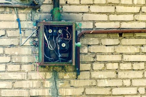 Old electrical panel with ceramic fuses on a brick wall Stock Photos