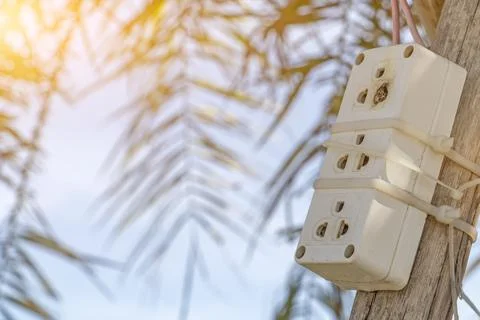 The old electrical plug next to the cream wall. Stock Photos