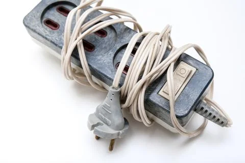 An old electrical power extension cable with european sockets and a cable wound Stock Photos