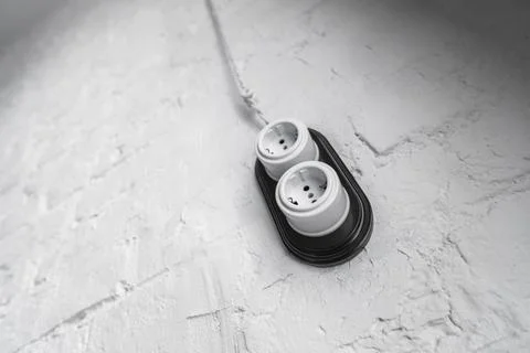 The old electrical socket in vintage style on a white brick wall Stock Photos