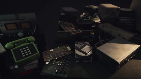 Old electronic components and devices scattered on a dark workbench Stock Footage 313980847