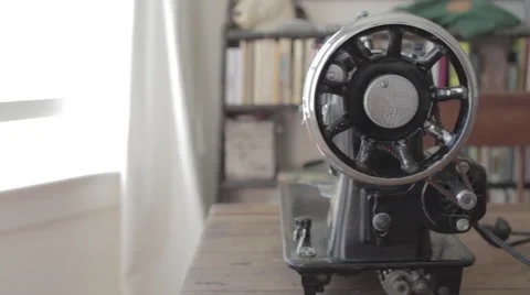 Old electronic sewing machine seen from the side in slow track from window 스톡 동영상 60724455