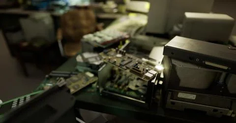 Old electronics and circuit boards scattered on a workbench in a workshop Stock Illustration