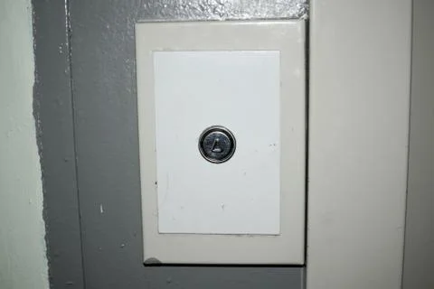 Old elevator call button at the entrance Foto stock
