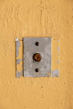 Old elevator call button with grungy pattern in a soviet building in post-soviet 写真素材