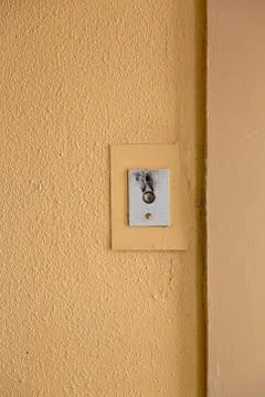 Old elevator call button with grungy pattern in a soviet building in post-soviet 写真素材