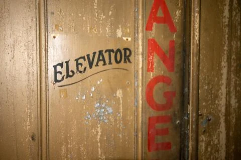 An Old Elevator Door With Old Fashioned Text That Says Elevator Stock Photos