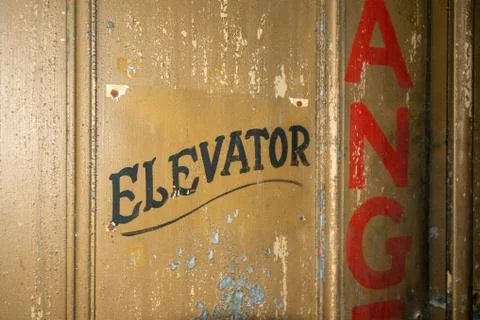 An Old Elevator Door With Old Fashioned Text That Says Elevator Stock Photos