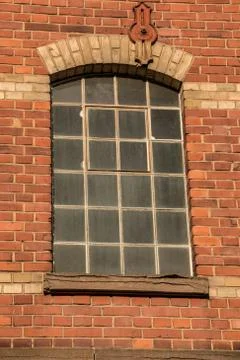 Old empty brick house factory with dark windows Stock Photos