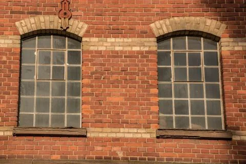 Old empty brick house factory with dark windows Stock Photos