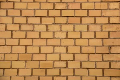 Old empty brick house factory wall with yellow bricks Stock Photos