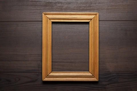 Old empty frame over wooden background Stock Photos