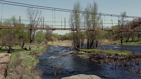 Old Empty Metal Pedestrian Bridge Across Small River At Countryside On Sunny Day Stock Footage 107126256