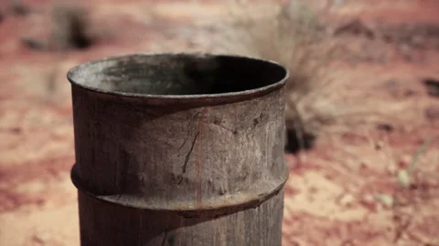 Old empty rusted barrel on sand Stock Footage 232989507
