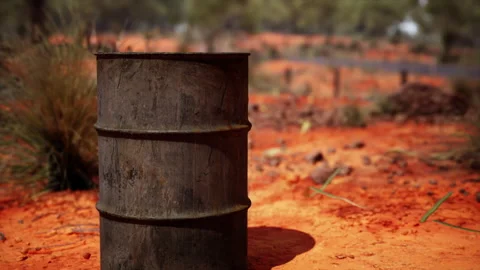 Old empty rusted barrel on sand Stock Footage 235301573