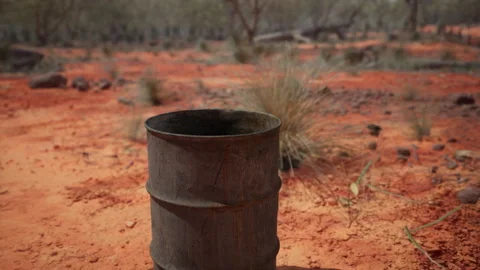 Old empty rusted barrel on sand Stock Footage 235622090