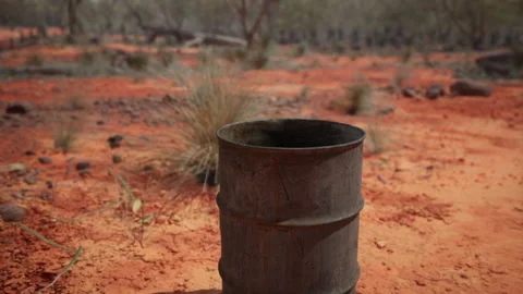 Old empty rusted barrel on sand Stock Footage 237880422