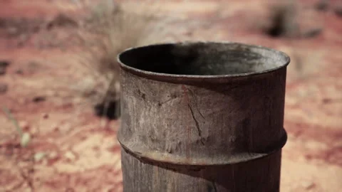 Old empty rusted barrel on sand Stock Footage 238747068