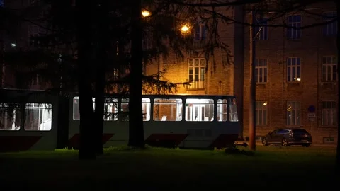 Old empty tram is passing by in the local park, autumn evening Stock Footage 310172230