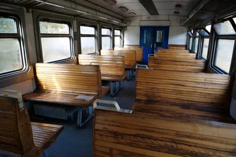 Old empty wagon of train. Wooden seats in an empty coach of train Photos