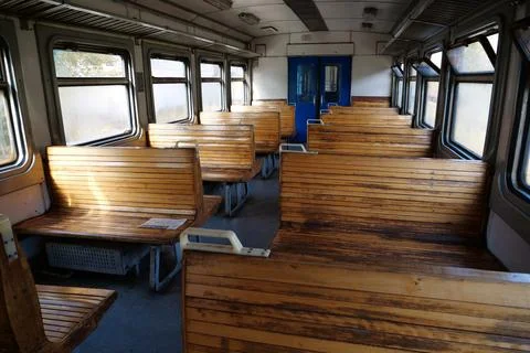 Old empty wagon of train. Wooden seats in an empty coach of train Photos