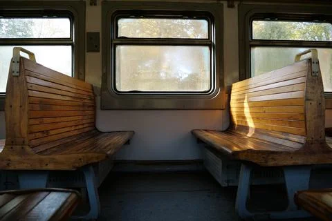 Old empty wagon of train. Wooden seats in an empty coach of train Stock Photos