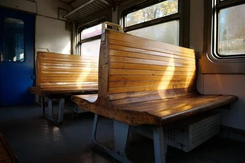 Old empty wagon of train. Wooden seats in an empty coach of train Stock Photos