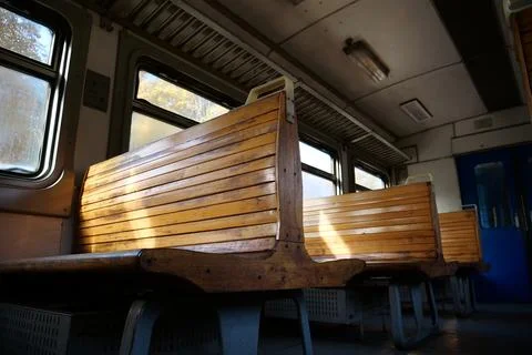 Old empty wagon of train. Wooden seats in an empty coach of train Fotos de archivo
