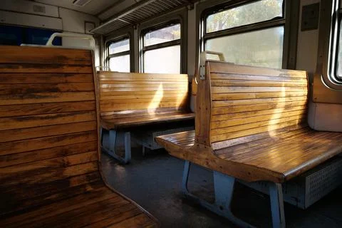 Old empty wagon of train. Wooden seats in an empty coach of train Stock Photos