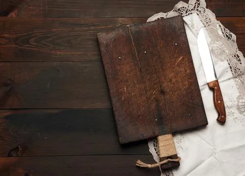Old empty wooden rectangular cutting board and knife Stock Photos